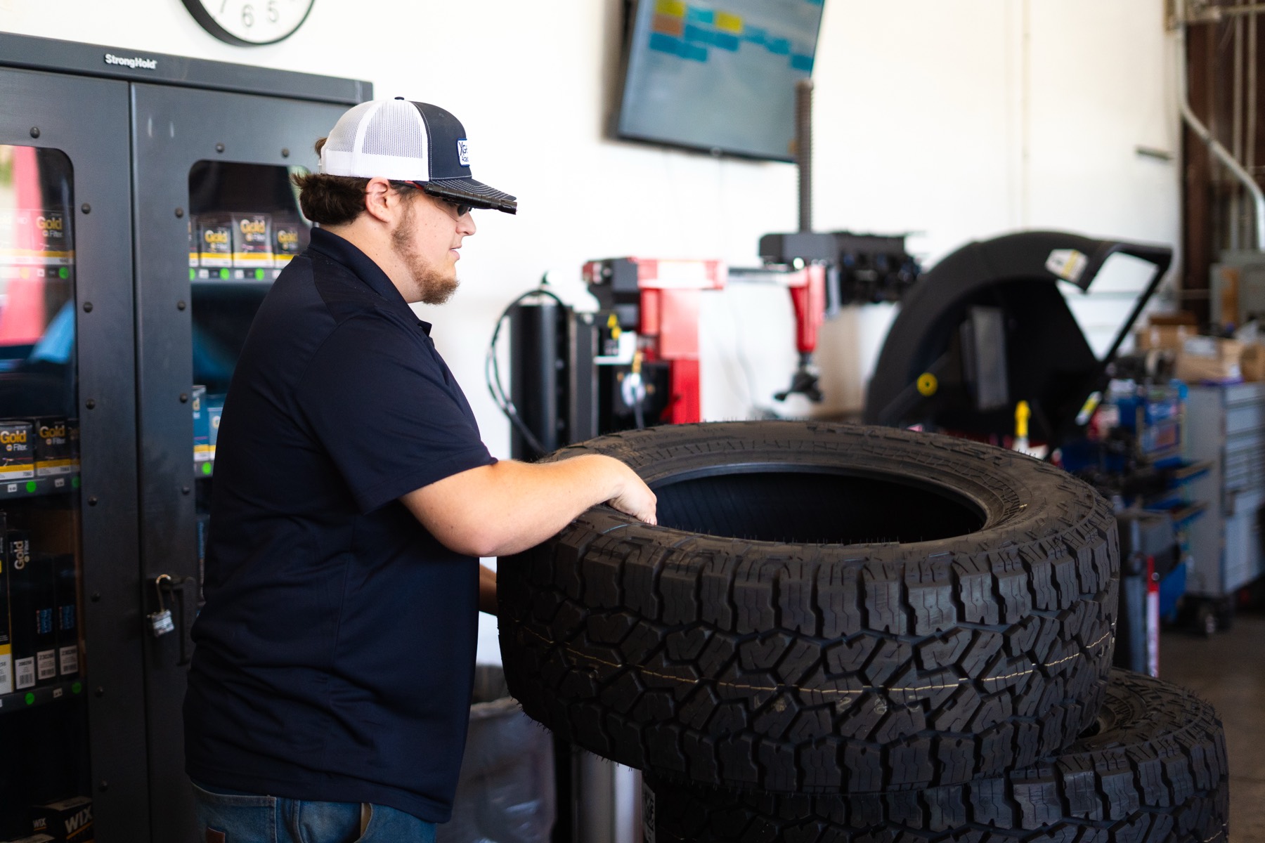 Student working with tires and shop supplies