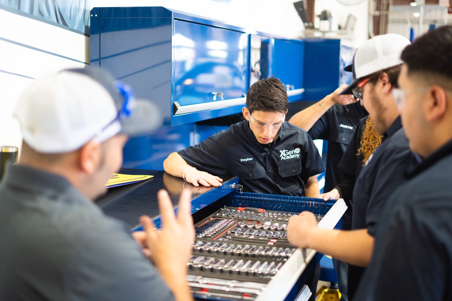 Student using hands-on automotive technology under the hood