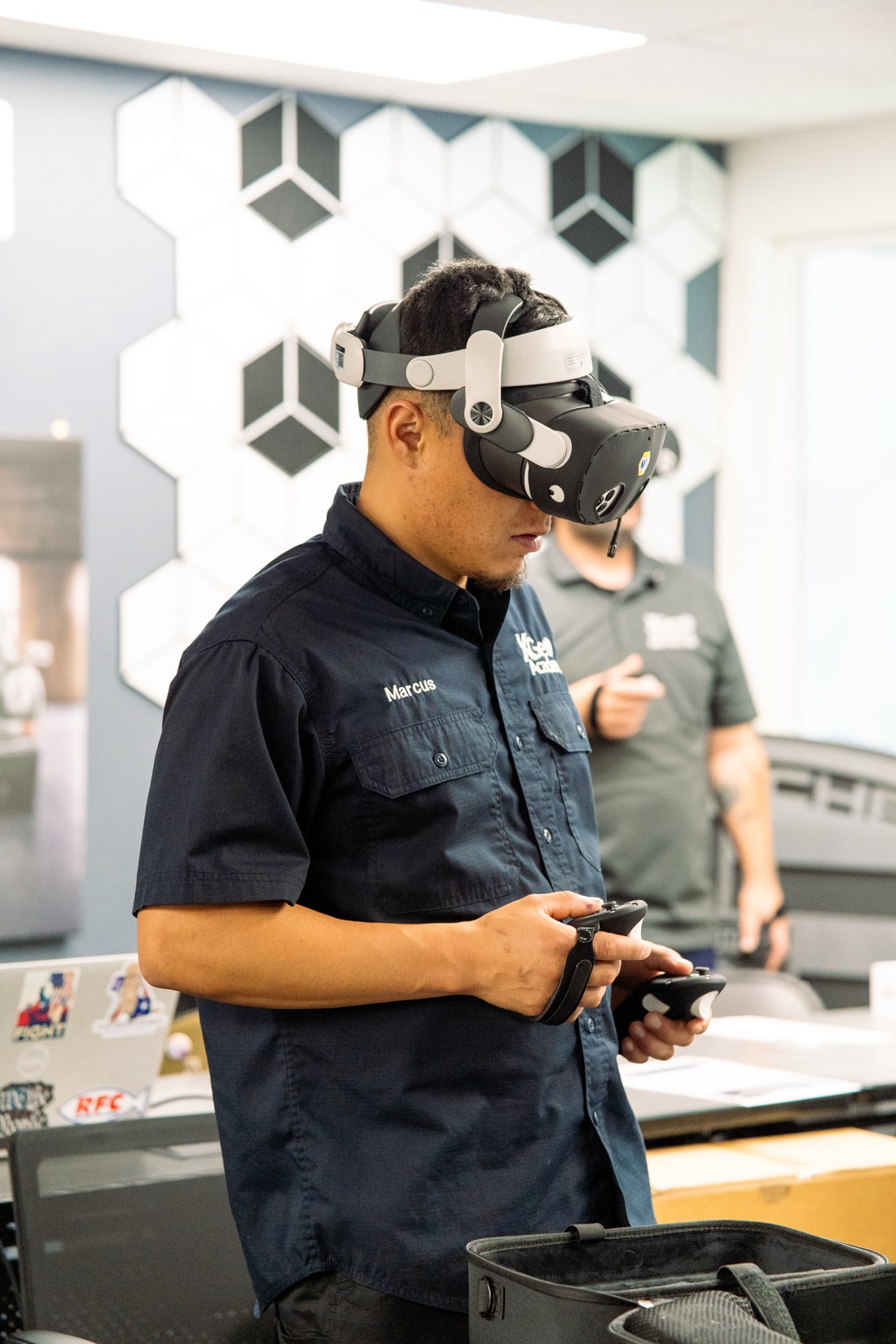 XGEN student using XR goggles and handheld controllers